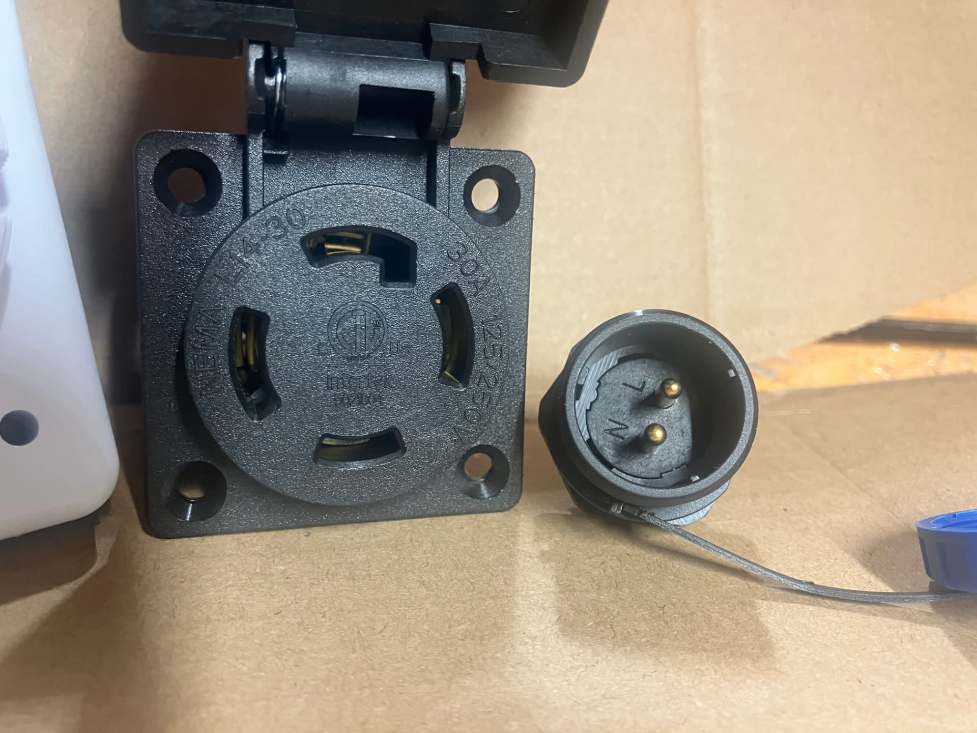 NEMA L14-30 30A twist-lock inlet receptacle shown next to the two-wire generator start connector